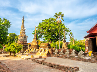 Wat Yai Chaimongkol, one of the UNESCO World Heritage place Ayudhaya, Thailand, ancient pagoda and buildings with surrounding a lot of buddha statues in outdoor under blue sky in summer