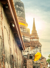 Wat Yai Chaimongkol, one of the UNESCO World Heritage place Ayudhaya, Thailand, ancient pagoda and buildings with surrounding a lot of buddha statues in outdoor under blue sky in summer