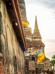 Wat Yai Chaimongkol, one of the UNESCO World Heritage place Ayudhaya, Thailand, ancient pagoda and buildings with surrounding a lot of buddha statues in outdoor under blue sky in summer