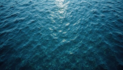 A shimmering surface of water with gentle waves reflecting sunlight, creating a tranquil and serene marine atmosphere.