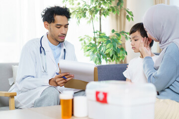 Asian muslim woman taking her son to see doctor in hospital