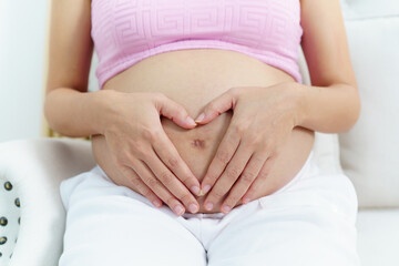 Asian pregnant woman relaxing at home.