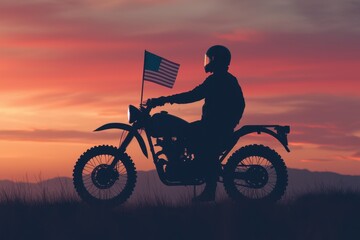 Fototapeta premium Silhouette of a Rider on a Motorcycle with American Flag at Sunset