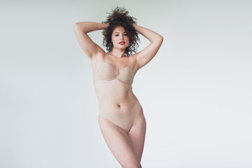 Fototapeta premium Confident young woman modeling natural beauty and lingerie with body positivity and confidence.