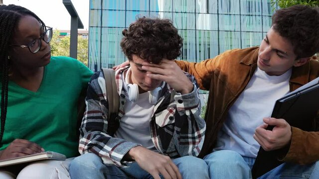 University students comforting their sad classmate