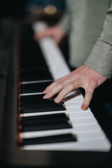 Obraz premium Detailed image showing a musician's hand playing piano keys, highlighting focus and practice. Perfect for concepts like music, skill development, dedication, and artistic expression.