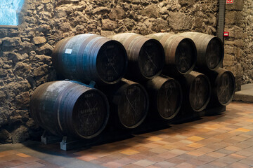 Wine cellar, row of wooden barrels
