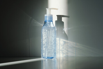 Tube of micellar gel in a ray of sunlight on a shadow background.