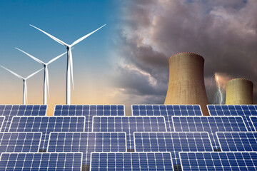 Solar panels with a nuclear power plant in the background. Comparison of two different energy sources. With wind turbines in the background.