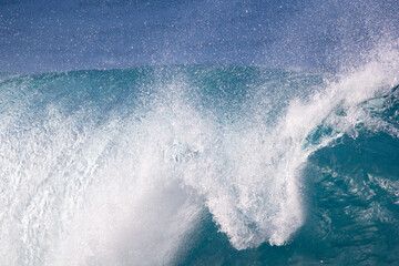 Crushing surf waves in crystal clear turquoise blue colour water close up