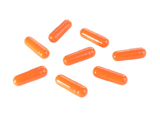 Bulk orange capsule pills isolated on white background.