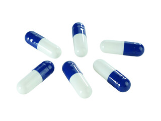 Bulk blue and white capsule pills isolated on white background.