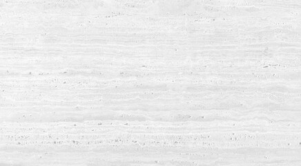 close-up of a white travertine stone surface, revealing its natural texture characterized by...