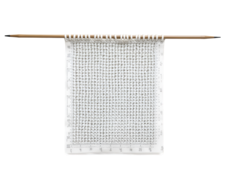 Detailed knitting chart visualization demonstrating intricate grid pattern and precise measurements with yarn, displayed on a measuring template for crafting projects