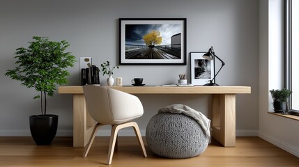 Modern minimalist home office with stylish desk, decorative plant, and framed artwork on a clean wall