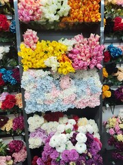 Shelves display a colorful array of flowers
