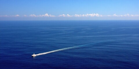Vast expanse of deep blue ocean with a small boat