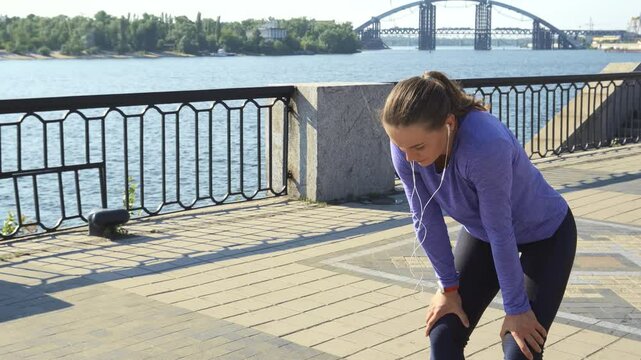 Young woman sprints into view and pauses to catch her breath