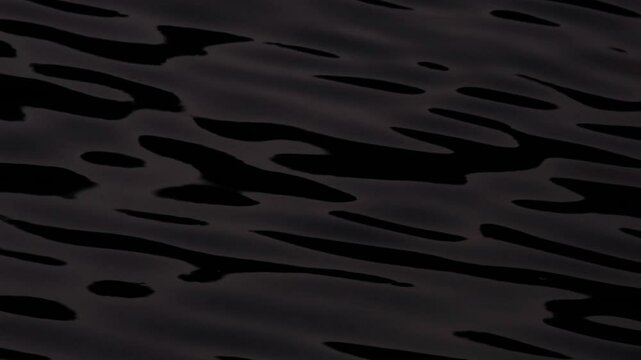 Beautiful reflections on dark blue or black water surface at night. Continuously changing wavy sea surface for background. Neutral mirror effect, dark shadows, calm and meditative evening nature.