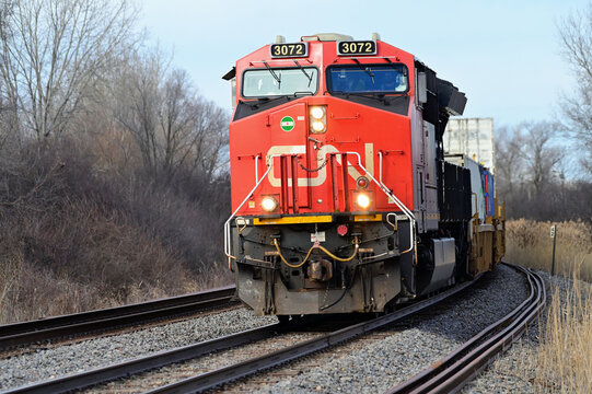 A Canadian National Railway locomotive leads a southbound container train into a curve along a stretch of double track in northwest suburban Chicago. 