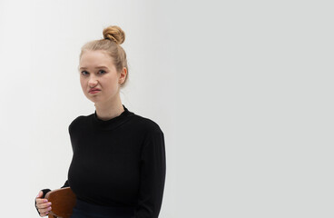 A young blonde girl wearing casual dark clothes has a disgusted expression, displeased and fearful,...