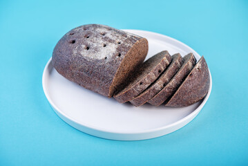 Rye bread in a plate on a blue background