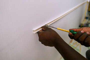 DIY wall repair with putty knife at home in afternoon