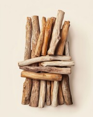 A collection of various wooden branches arranged artistically on a neutral background.
