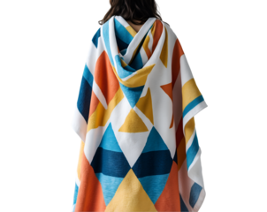 Stylish woman draped in a vibrant beach towel with a geometric print, showcasing a blend of comfort and modern design on a neutral backdrop