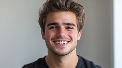 Fototapeta premium Confident young man smiling indoor setting portrait casual environment close-up