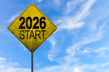 Naklejka premium 2026 Metal signpost with yellow dirty road sign. Image of a signpost pointing in the direction of the year 2026
