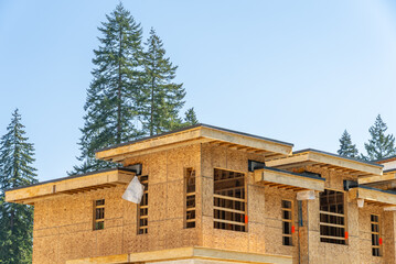Modern apartment building under construction. The site with wooden frame in Vancouver, Canada, North America. Day time on April 2025.