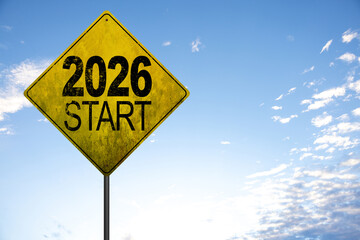 2026 Metal signpost with yellow dirty road sign. Image of a signpost pointing in the direction of the year 2026