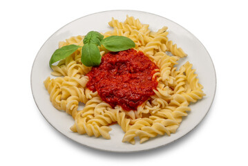 Fusilli macaroni pasta with tomato sauce and basil leaf in plate isolated