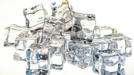 Ice cubes on a white background, dotted with water droplets. The soft light and blue nuances...