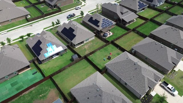 Brand new two-story suburban houses with solar panel roofs in rapid growing Princeton, Collin County, North Texas, clean energy efficiency home suburb DFW metroplex, large backyard, wooden fence