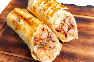 Delicious wrapped dish featuring savory filling on wooden board