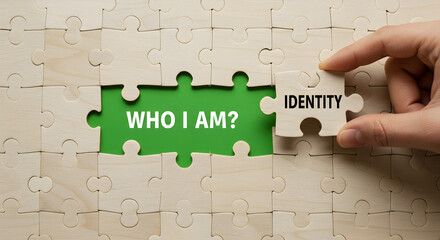 Hand Completes Puzzle with Identity Piece Revealing Who I Am Question on Green Background