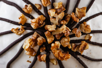 Pancho cake with pineapple and sour cream topped with chocolate and walnut, closeup. Top view.