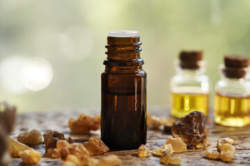 A bottle of frankincense essential oil with frankincense resin