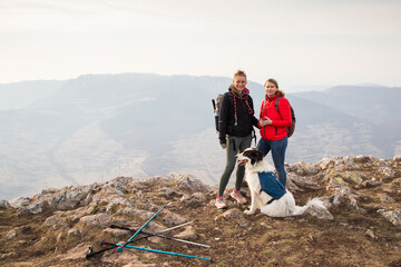 happy fit woman trekking with her dog