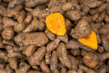 Fresh raw turmeric at a food market for sale in Tanzania, Africa.