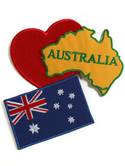 Flat lay of Australia map and flag over a red heart on a vertical white background , designed for use in tourism campaigns , holiday visuals , or national celebration designs.