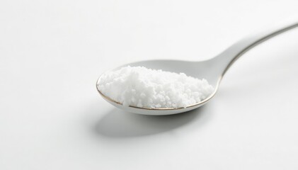 Spoonful of white sugar against white backdrop, white spoon, spoon
