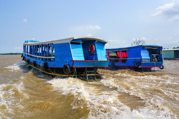Wooden tourist ferries traffic in the Mekong river delta, Vietnam