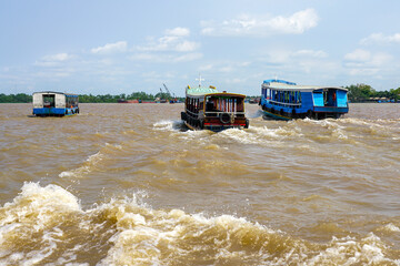 Traditional wooden tourist ferries traffic in the Mekong delta, Vietnam