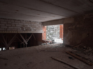 An intriguing view of an abandoned building, with natural light beautifully filtering through a...