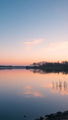Fototapeta premium Tranquil Lake Reflection at Sunset: Serene Nature and Pastel Evening Vista