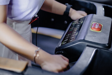 Naklejka premium Activating Cardio Machine: Person Interacting with Treadmill Con