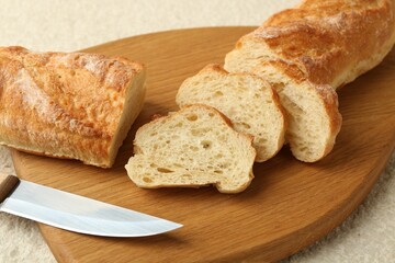 Slices of fresh bread on light textured table, closeup